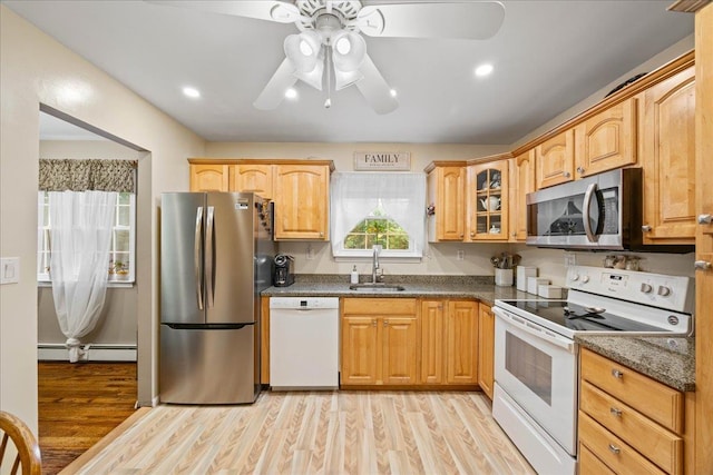 273 N Brewster Rd, Brewster, NY 10509 - kitchen with appliances with stainless steel finishes, a baseboard radiator, light wood-type flooring, a ceiling fan, and glass insert cabinets