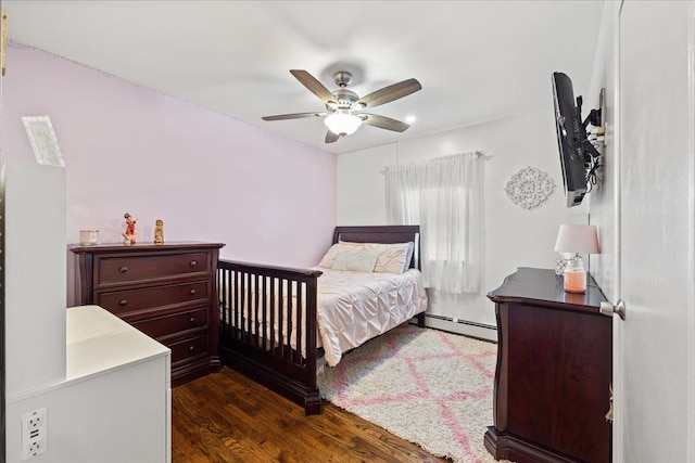 273 N Brewster Rd, Brewster, NY 10509 - bedroom with a baseboard heating unit, dark wood-style flooring, and ceiling fan