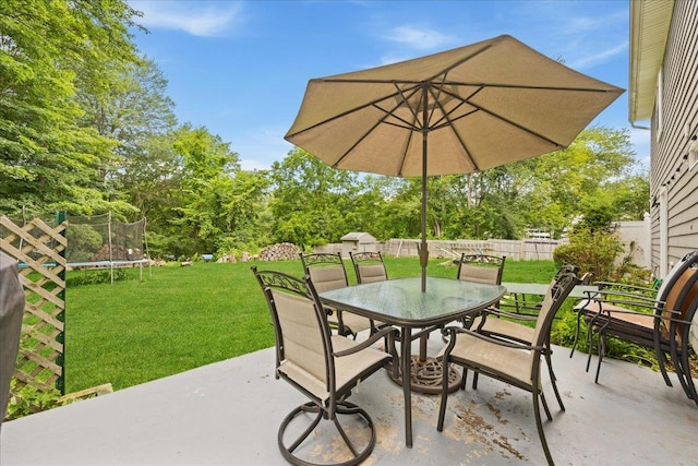 273 N Brewster Rd, Brewster, NY 10509 - view of patio featuring a trampoline, outdoor dining space, and view of scattered trees