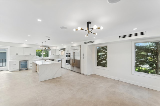 141 Flamingo St, Atlantic Beach, NY 11509 - kitchen featuring wine cooler, stainless steel appliances, a chandelier, a center island with sink, and recessed lighting