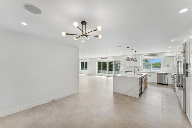 141 Flamingo St, Atlantic Beach, NY 11509 - kitchen featuring stainless steel dishwasher, a chandelier, a center island with sink, recessed lighting, and hanging light fixtures