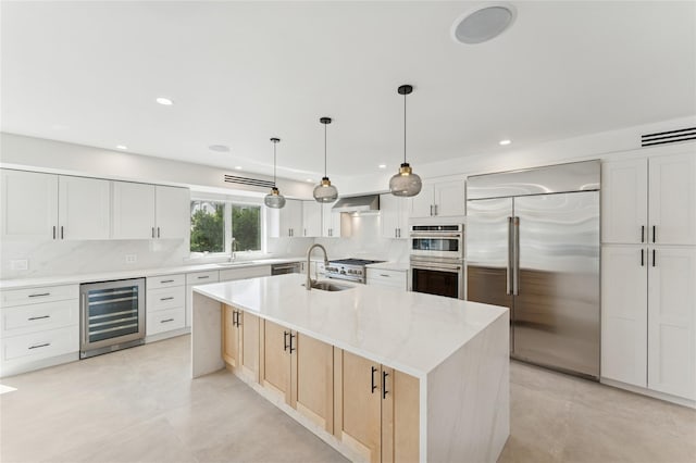 141 Flamingo St, Atlantic Beach, NY 11509 - kitchen featuring appliances with stainless steel finishes, beverage cooler, wall chimney exhaust hood, decorative backsplash, and recessed lighting
