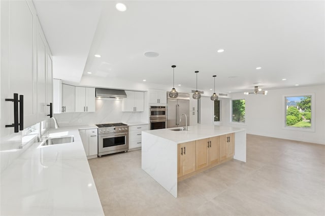 141 Flamingo St, Atlantic Beach, NY 11509 - kitchen with premium appliances, wall chimney exhaust hood, a spacious island, recessed lighting, and open floor plan