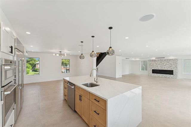 141 Flamingo St, Atlantic Beach, NY 11509 - kitchen featuring open floor plan, appliances with stainless steel finishes, a center island with sink, recessed lighting, and decorative light fixtures