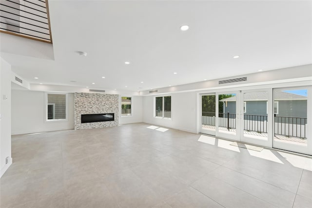 141 Flamingo St, Atlantic Beach, NY 11509 - unfurnished living room featuring plenty of natural light, recessed lighting, a fireplace, and light tile patterned floors