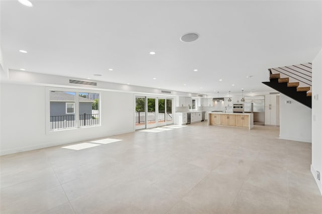 141 Flamingo St, Atlantic Beach, NY 11509 - unfurnished living room with stairs and recessed lighting