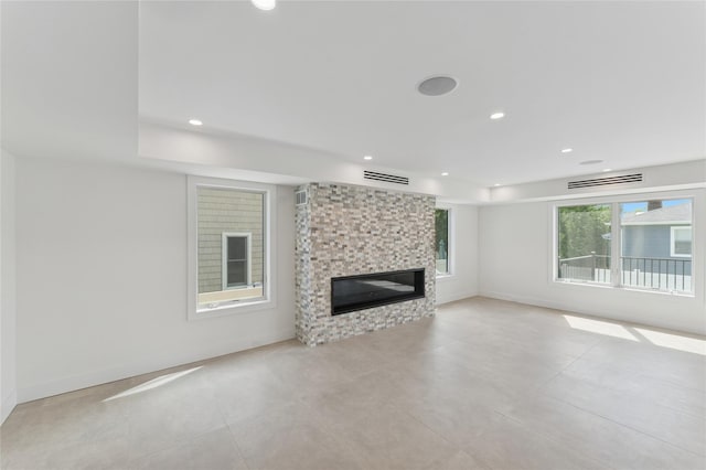 141 Flamingo St, Atlantic Beach, NY 11509 - unfurnished living room featuring a fireplace, recessed lighting, and light tile patterned floors