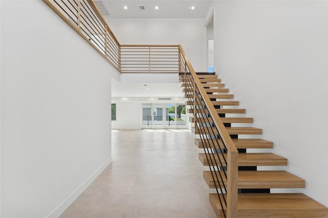 141 Flamingo St, Atlantic Beach, NY 11509 - staircase featuring a high ceiling and recessed lighting