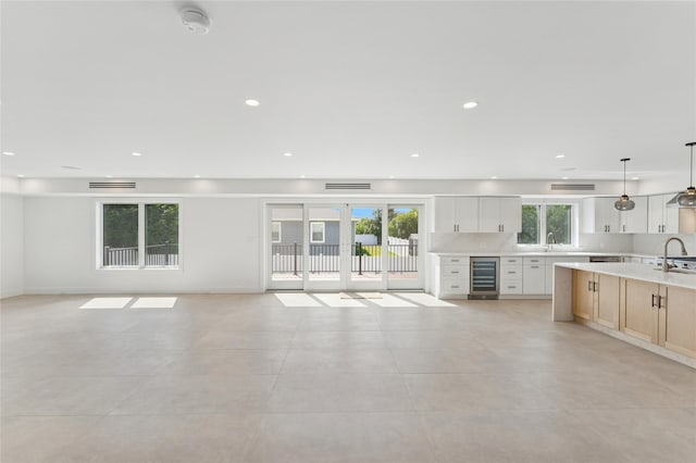141 Flamingo St, Atlantic Beach, NY 11509 - unfurnished living room featuring beverage cooler, light tile patterned floors, and recessed lighting