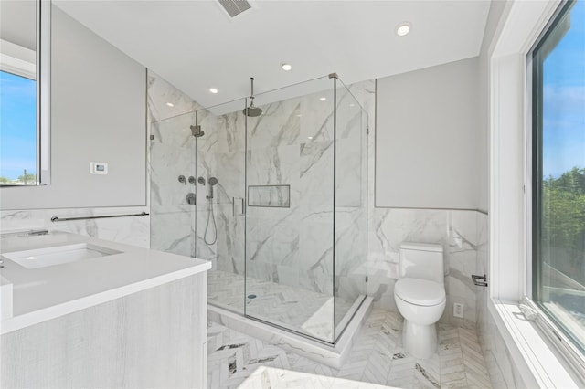 141 Flamingo St, Atlantic Beach, NY 11509 - bathroom with tile walls, a marble finish shower, recessed lighting, vanity, and wainscoting