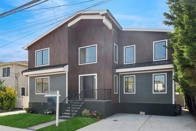 141 Flamingo St, Atlantic Beach, NY 11509 - modern home featuring a standing seam roof, a metal roof, and a front lawn