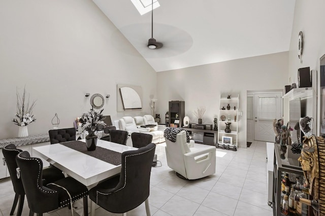 27 Primrose Ln, North Babylon, NY 11703 - dining space with high vaulted ceiling, ceiling fan, light tile patterned floors, and a skylight