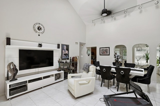 27 Primrose Ln, North Babylon, NY 11703 - living area with arched walkways, track lighting, high vaulted ceiling, and light tile patterned floors