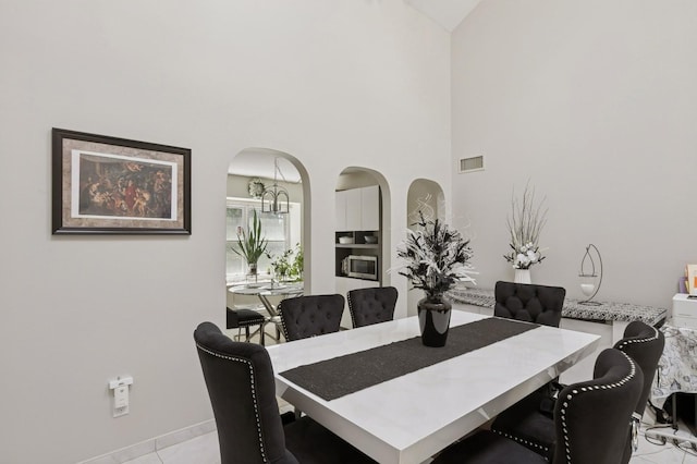 27 Primrose Ln, North Babylon, NY 11703 - dining area with a high ceiling and arched walkways