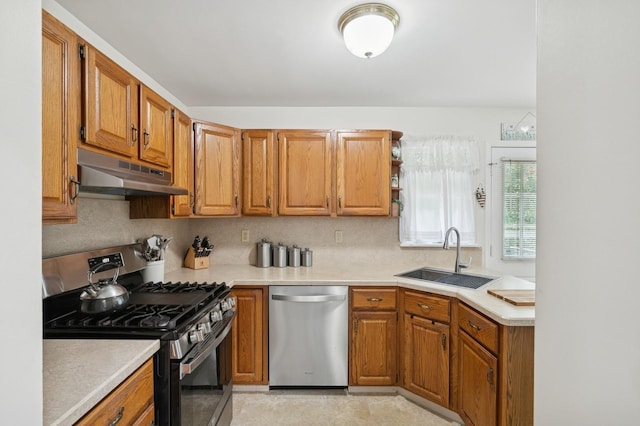 27 Primrose Ln, North Babylon, NY 11703 - kitchen featuring stainless steel appliances, under cabinet range hood, light countertops, and brown cabinetry