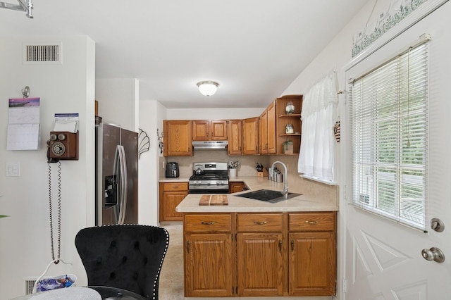 27 Primrose Ln, North Babylon, NY 11703 - kitchen featuring appliances with stainless steel finishes, under cabinet range hood, brown cabinetry, open shelves, and a peninsula