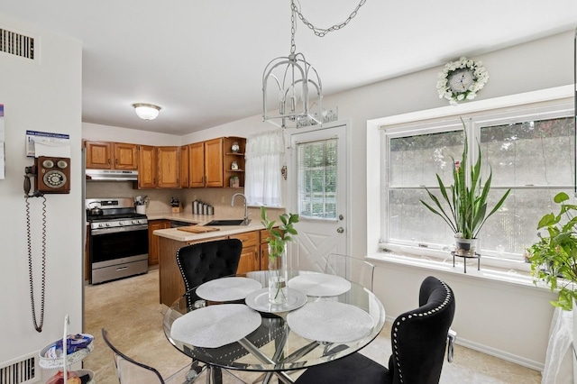 27 Primrose Ln, North Babylon, NY 11703 - dining space with a chandelier