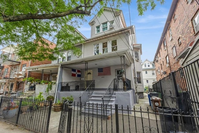 4808 92nd St, Elmhurst, NY 11373 - view of front of house featuring a porch and a fenced front yard