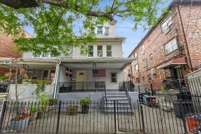 4808 92nd St, Elmhurst, NY 11373 - view of front facade with a fenced front yard, a porch, and a gate