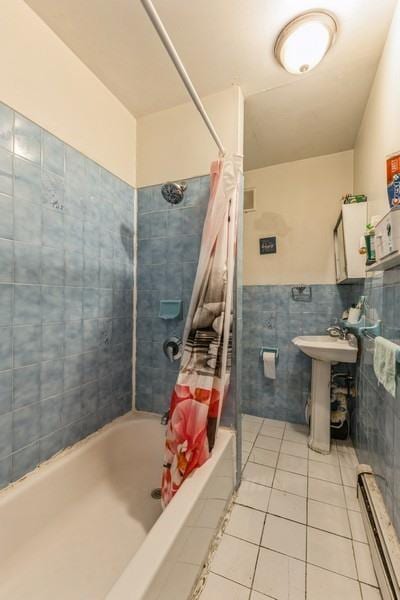 4808 92nd St, Elmhurst, NY 11373 - bathroom with shower / bathtub combination with curtain, tile patterned flooring, tile walls, a baseboard radiator, and wainscoting