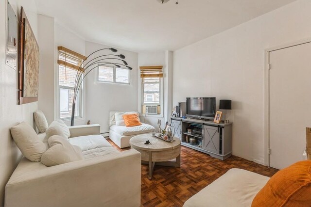 4808 92nd St, Elmhurst, NY 11373 - living room featuring baseboard heating and cooling unit