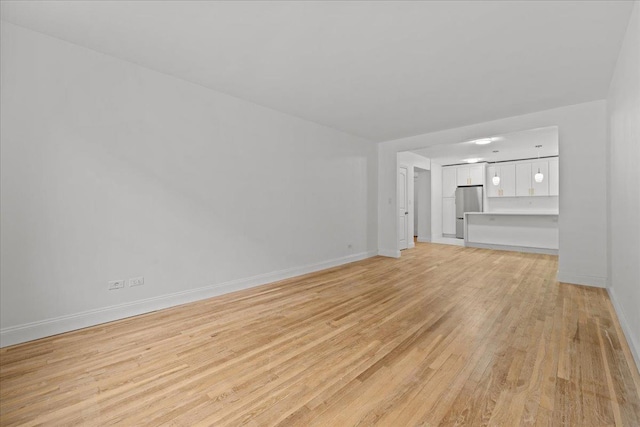 2107 Wallace Ave Unit 4G, Bronx, NY 10462 - unfurnished living room with light wood finished floors and baseboards