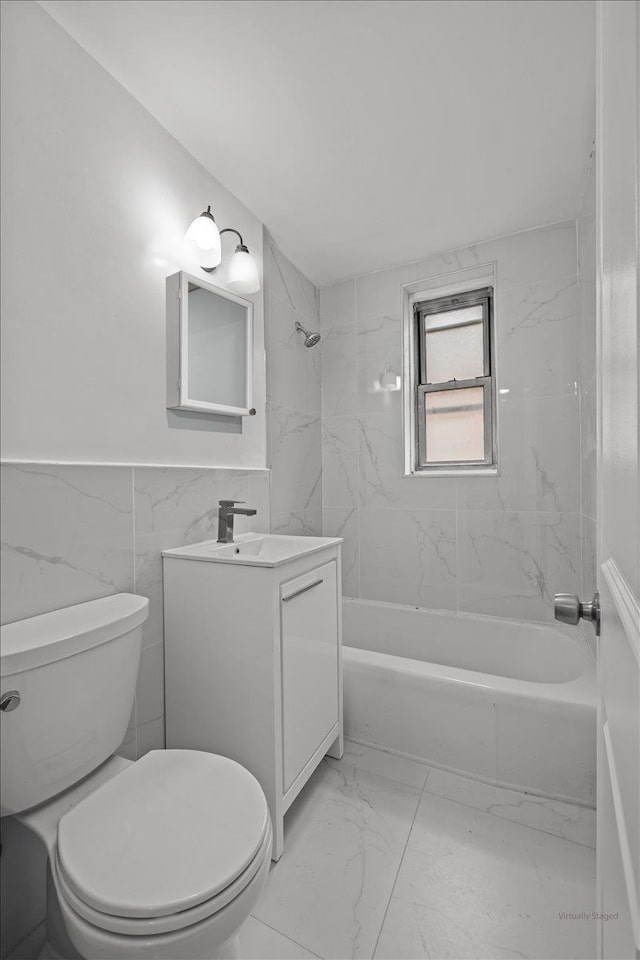 2107 Wallace Ave Unit 4G, Bronx, NY 10462 - bathroom with marble look tile flooring, vanity, bathing tub / shower combination, tile walls, and wainscoting