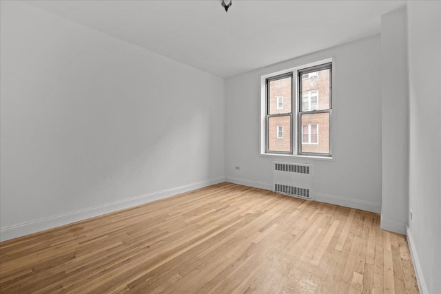 2107 Wallace Ave Unit 4G, Bronx, NY 10462 - spare room featuring radiator heating unit and light wood finished floors