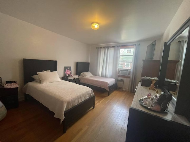 20-39 150th St, Whitestone, NY 11357 - bedroom with radiator heating unit, light wood finished floors, and cooling unit