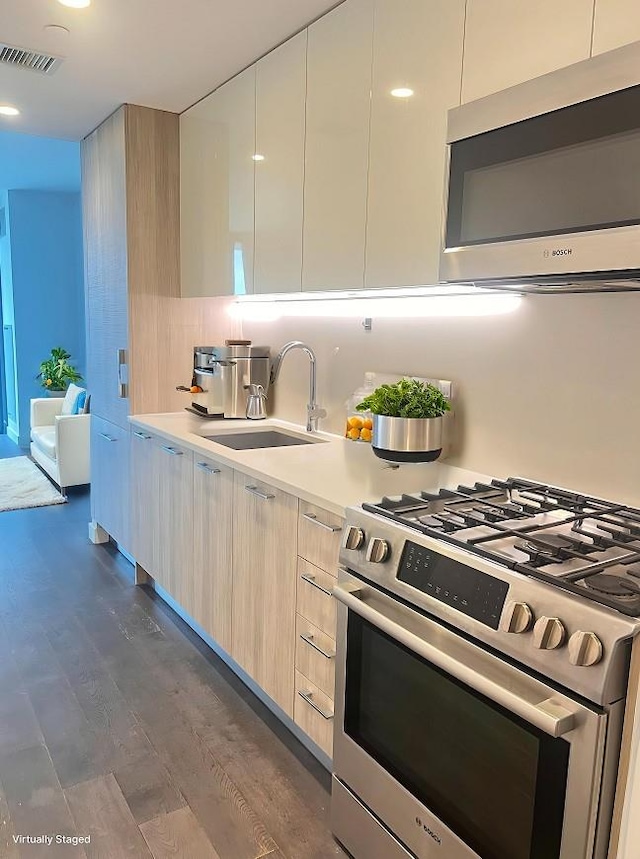 131-05 40th Rd Unit 17T, Flushing, NY 11354 - kitchen with appliances with stainless steel finishes, modern cabinets, dark wood finished floors, light countertops, and backsplash