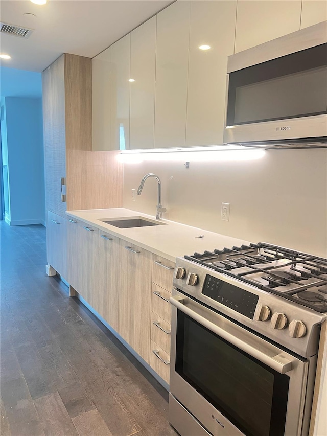 131-05 40th Rd Unit 17T, Flushing, NY 11354 - kitchen featuring appliances with stainless steel finishes, modern cabinets, dark wood-style flooring, and light countertops