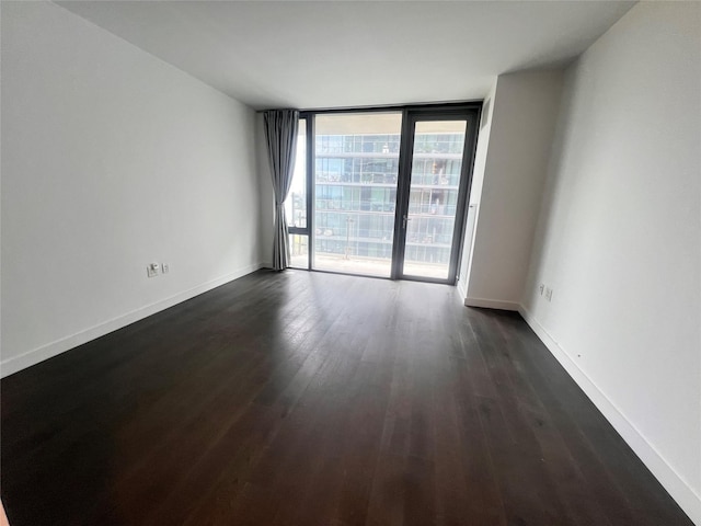 131-05 40th Rd Unit 17T, Flushing, NY 11354 - spare room with dark wood-style flooring and a wall of windows