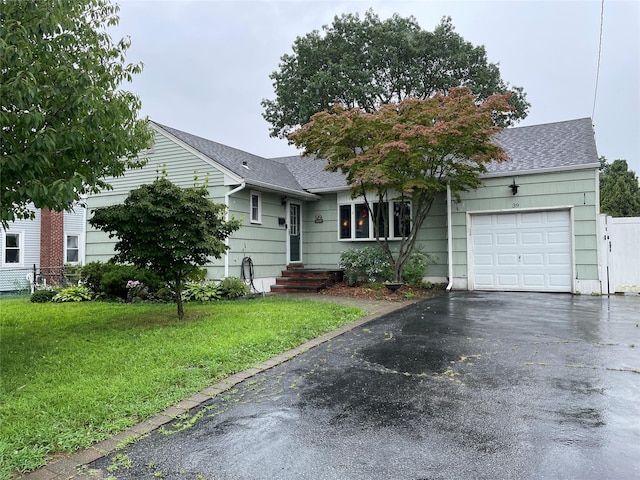 39 Herbert Ave, Lindenhurst, NY 11757 - ranch-style house with an attached garage, a shingled roof, and asphalt driveway