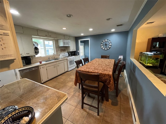 39 Herbert Ave, Lindenhurst, NY 11757 - kitchen with white appliances, white cabinetry, recessed lighting, light countertops, and light tile patterned floors