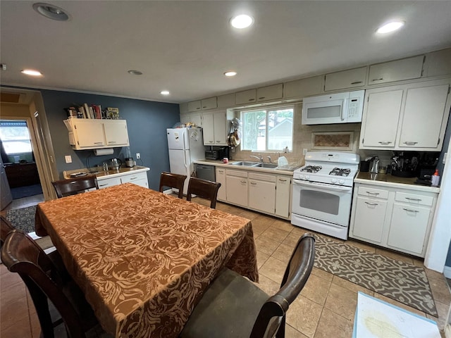 39 Herbert Ave, Lindenhurst, NY 11757 - kitchen with white appliances, light countertops, white cabinetry, light tile patterned floors, and recessed lighting
