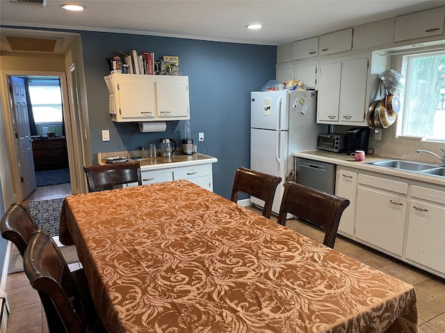 39 Herbert Ave, Lindenhurst, NY 11757 - kitchen featuring light countertops, light tile patterned flooring, freestanding refrigerator, white cabinets, and recessed lighting
