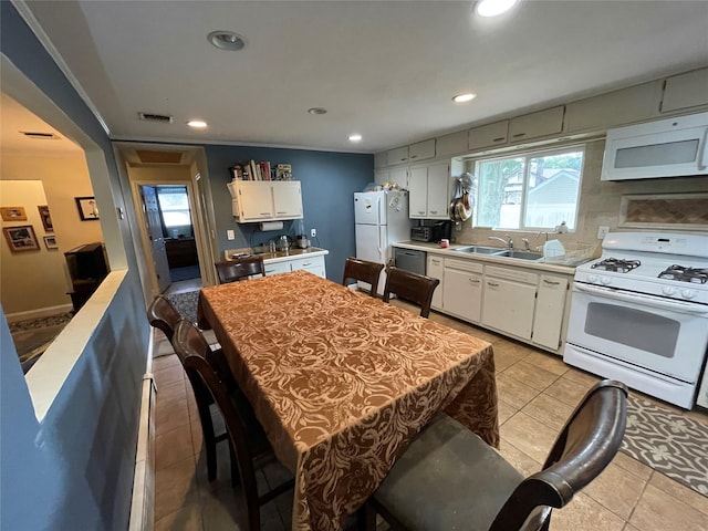 39 Herbert Ave, Lindenhurst, NY 11757 - kitchen with white appliances, white cabinetry, light countertops, light tile patterned floors, and recessed lighting