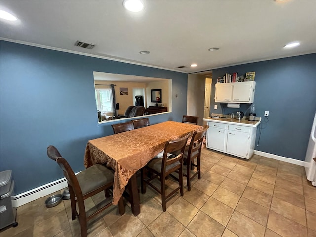 39 Herbert Ave, Lindenhurst, NY 11757 - dining space featuring baseboard heating, recessed lighting, ornamental molding, and light tile patterned floors