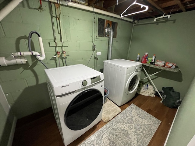 39 Herbert Ave, Lindenhurst, NY 11757 - laundry area featuring washing machine and dryer, concrete block wall, and wood finished floors