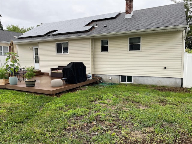 39 Herbert Ave, Lindenhurst, NY 11757 - rear view of property with a lawn, a chimney, and solar panels