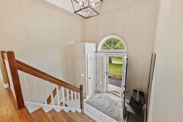 9 Carol Ct, Brewster, NY 10509 - foyer with a chandelier, stairway, a high ceiling, and tile patterned flooring