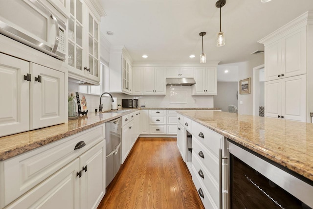 9 Carol Ct, Brewster, NY 10509 - kitchen with wine cooler, under cabinet range hood, white cabinets, decorative backsplash, and recessed lighting