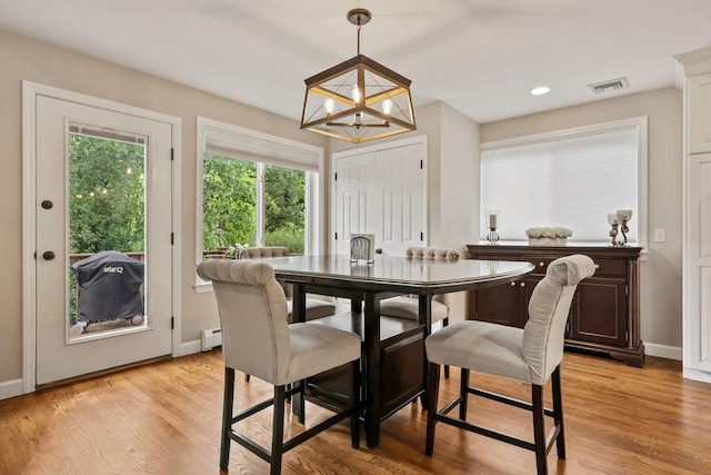 9 Carol Ct, Brewster, NY 10509 - dining space featuring a chandelier, a baseboard heating unit, light wood-style flooring, and recessed lighting