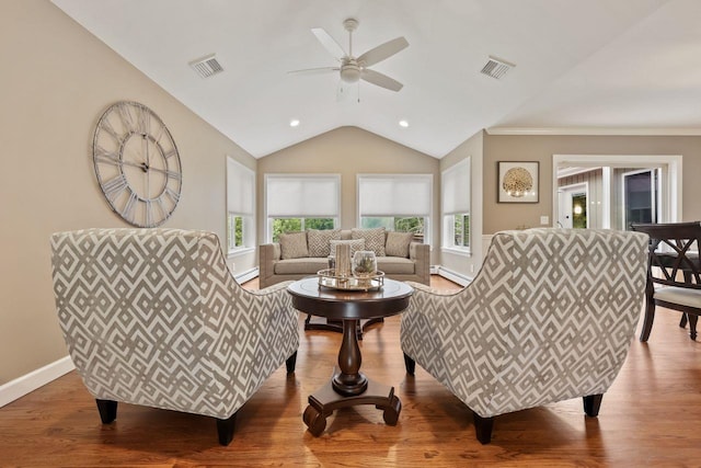 9 Carol Ct, Brewster, NY 10509 - living area with baseboard heating, plenty of natural light, ceiling fan, vaulted ceiling, and wood finished floors