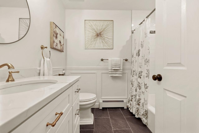 9 Carol Ct, Brewster, NY 10509 - bathroom featuring baseboard heating, vanity, shower / tub combo with curtain, wainscoting, and a decorative wall