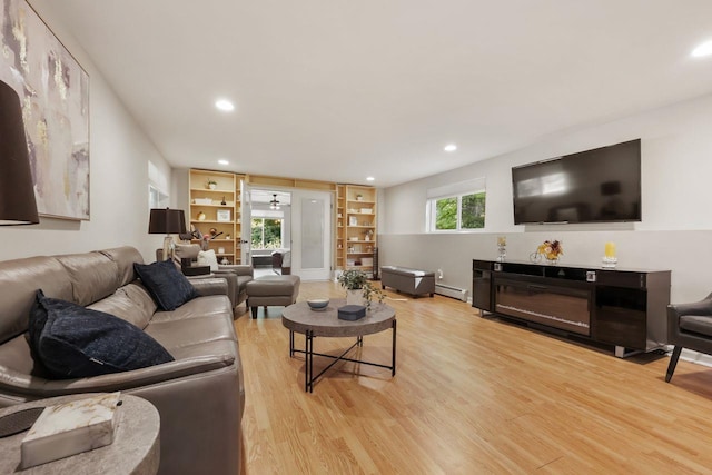9 Carol Ct, Brewster, NY 10509 - living area with light wood-type flooring, baseboard heating, recessed lighting, and built in shelves