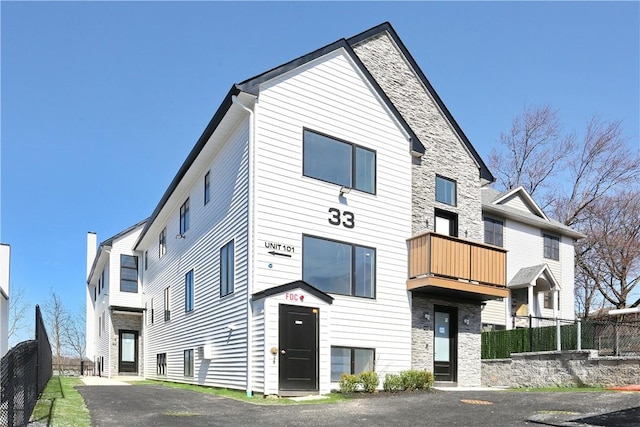 33 Ewing Ave Unit 102, Spring Valley, NY 10977 - view of front of house with a balcony and stone siding