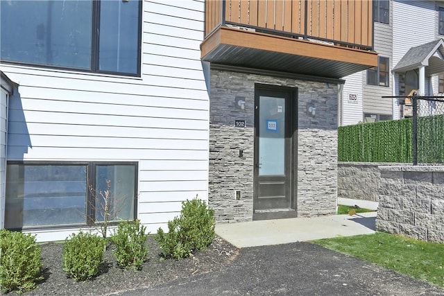 33 Ewing Ave Unit 102, Spring Valley, NY 10977 - view of exterior entry featuring a balcony and stone siding