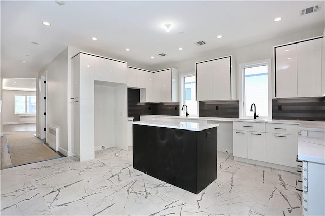 33 Ewing Ave Unit 102, Spring Valley, NY 10977 - kitchen with modern cabinets, recessed lighting, white cabinetry, healthy amount of natural light, and a kitchen island