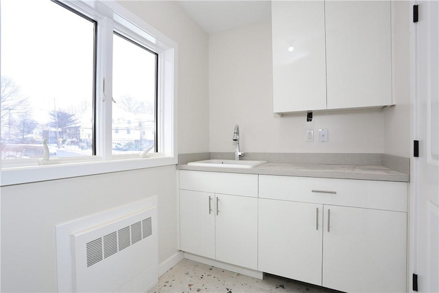 33 Ewing Ave Unit 102, Spring Valley, NY 10977 - kitchen with white cabinetry, light countertops, and radiator